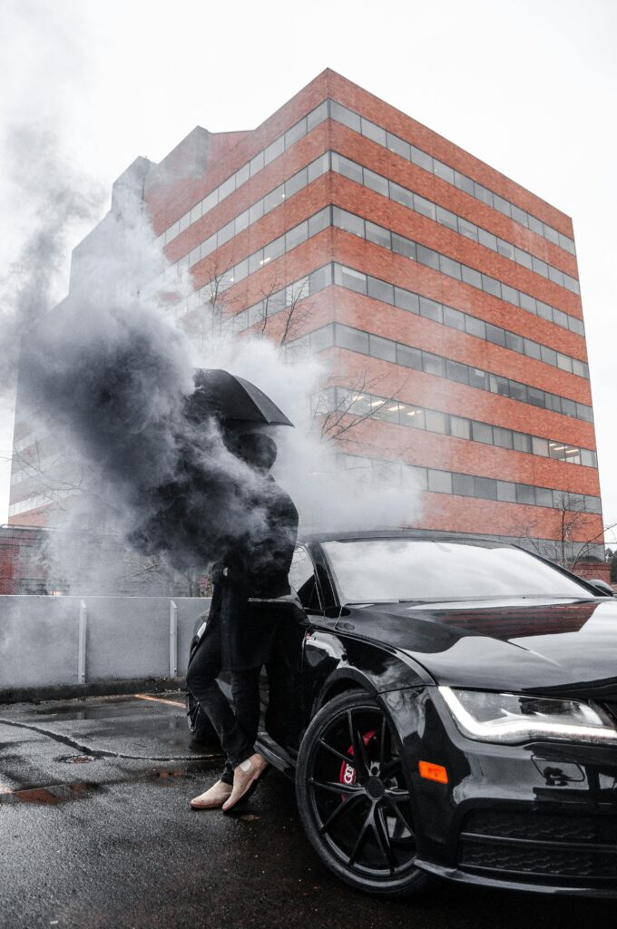 pexels-photo-2050244-2050244 Stylish luxury car with smoke effect in urban Portland setting reflecting modern design.